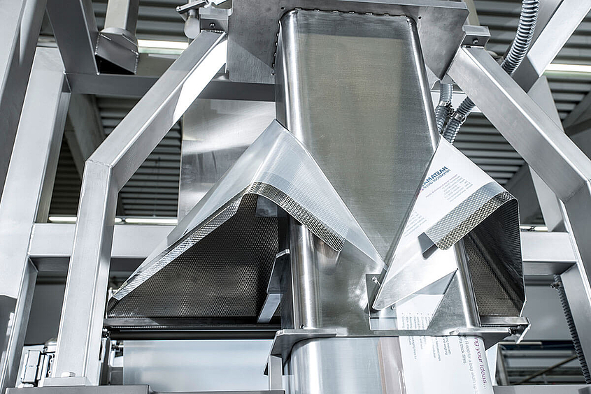 Forming shoulder of a vertical form fill and seal machine Detailed view of the forming shoulder in a vertical form fill and seal machine
